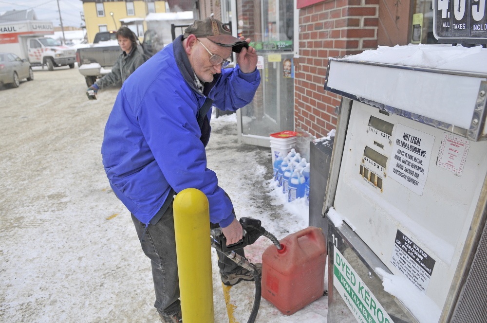 HOME HEAT: James O’Clair, 59, of Waterville, fills a gas can with kerosene at the Big Apple on Elm Street in Waterville on Saturday. O’Clair needs the fuel at home to get him through until Monday when he can have more heating fuel delivered.