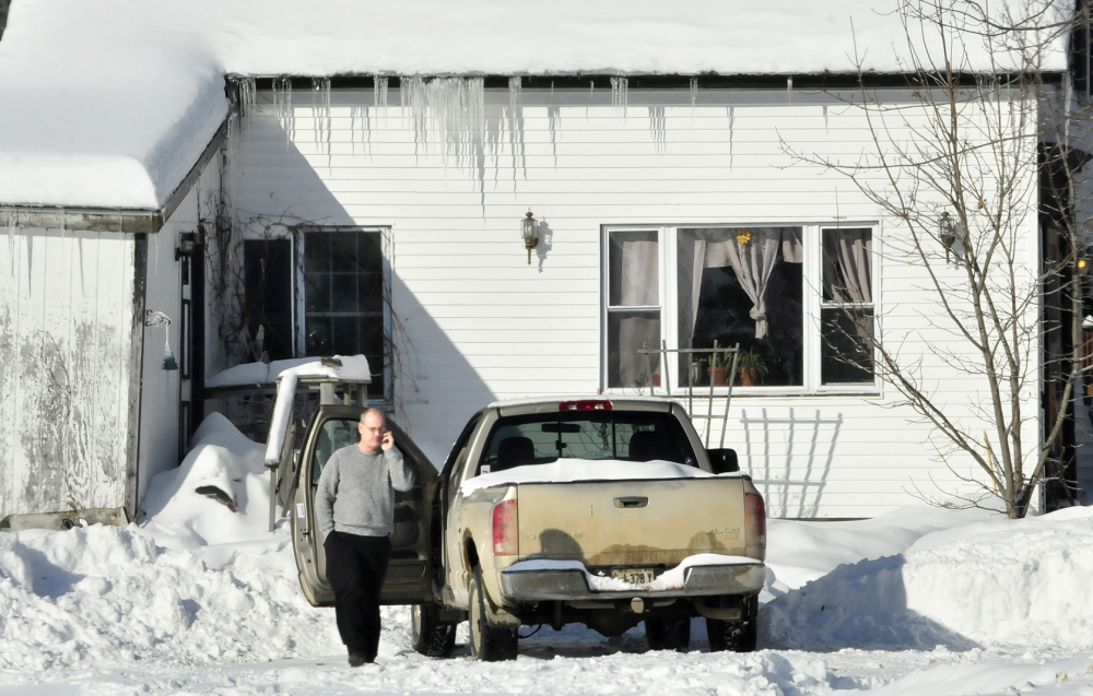 SHOOTING SCENE: Clinton police officer Rusty Bell investigates the scene where a man threatened a woman who fled the home on the Horseback Road in Clinton on Sunday, Jan. 5, 2014.