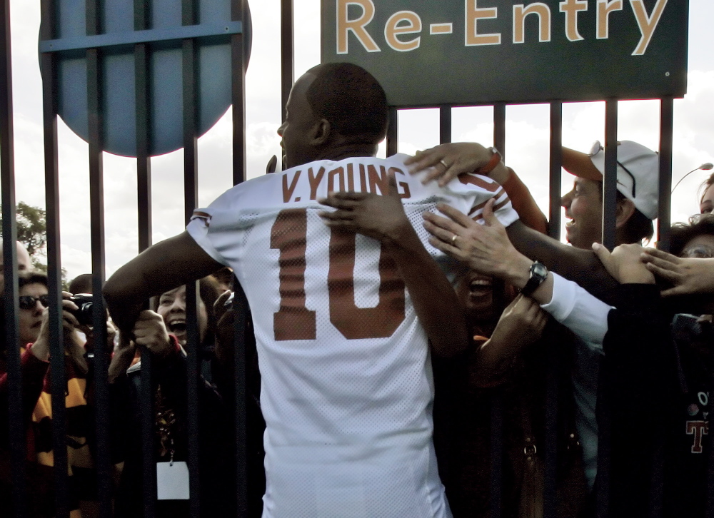 University of Texas quarterback Vince Young is hugged by fans at the gate of the Rose Bowl in Pasadena, Calif., on Jan. 3, 2006.