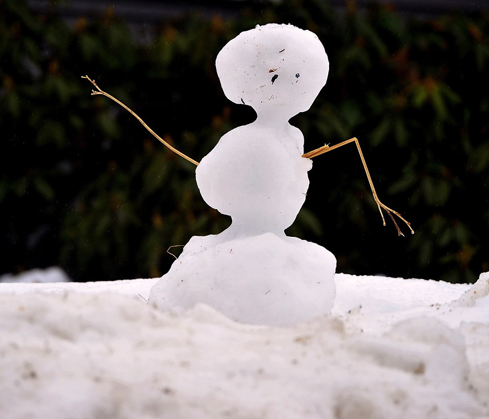 A snowman slowly dissolves in the rain in Yarmouth on Monday.