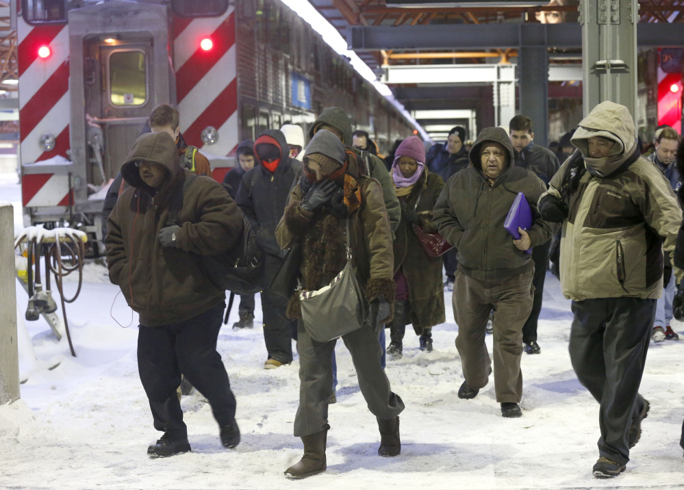 Commuters arrive at the La Salle Street commuter rail station as they experience temperatures well below zero and wind chills expected to reach 40 to 50 below on Monday in Chicago.