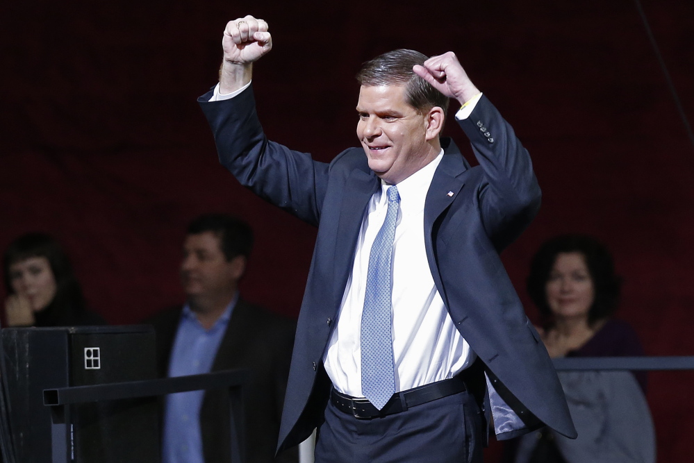Boston Mayor Marty Walsh raises his arms as he leaves the podium following his swearing-in ceremoniey in Conte Forum at Boston College. Walsh, who overcame childhood cancer and struggled with alcoholism as a young adult, emerged from an initial field of 12 contenders to succeed Thomas Menino, Boston’s longest-serving chief executive.