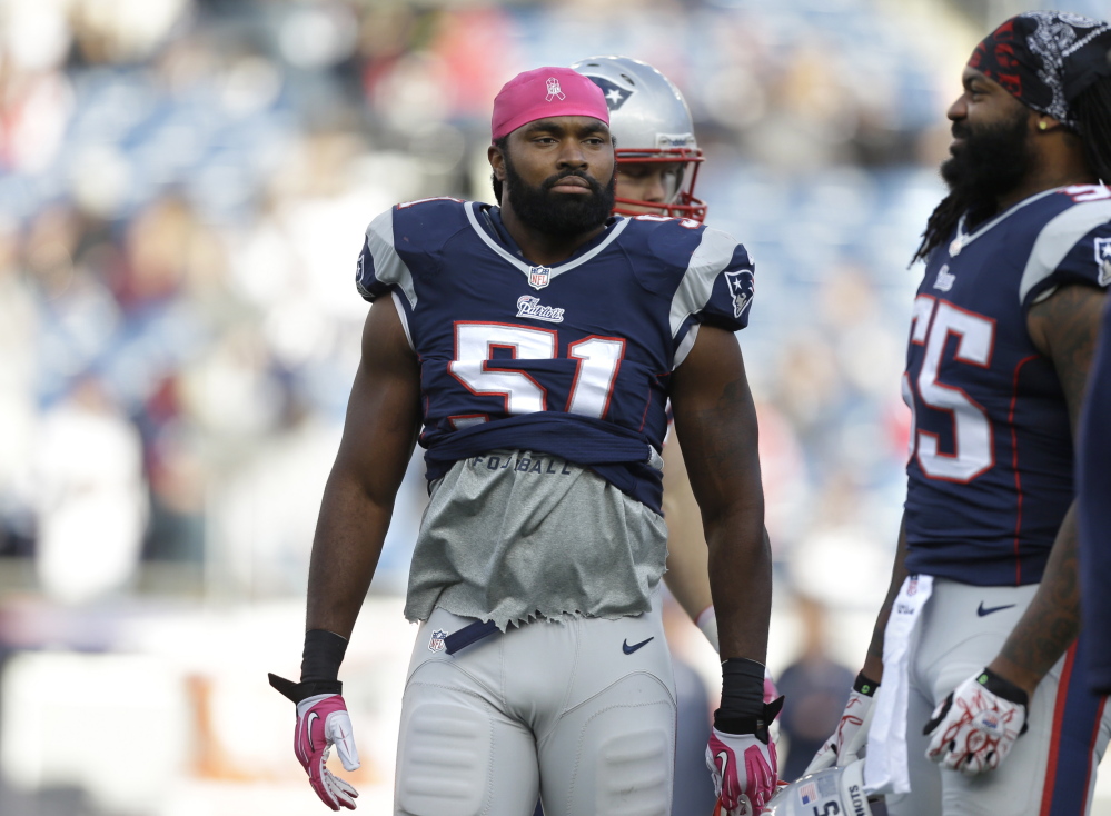 New England Patriots middle linebacker Brandon Spikes (55), right, warms up on the field before an NFL football game against the New Orleans Saints. New England’s defense suffered another big blow Monday when the Patriots’ placed linebacker Brandon Spikes on injured reserve because of a knee injury five days before their playoff game against Indianapolis.
