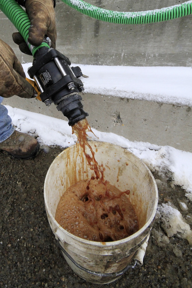 In a demonstration, a bucket is filled with beet juice at the Pennsylvania Department of Transportation’s Butler, Pa., maintenance facility, on Monday, Because rock salt is largely ineffective below 16 degrees, road salt is mixed with additives, such as beet juice and cheese brine, to keep it working in temperatures as low as minus 25.