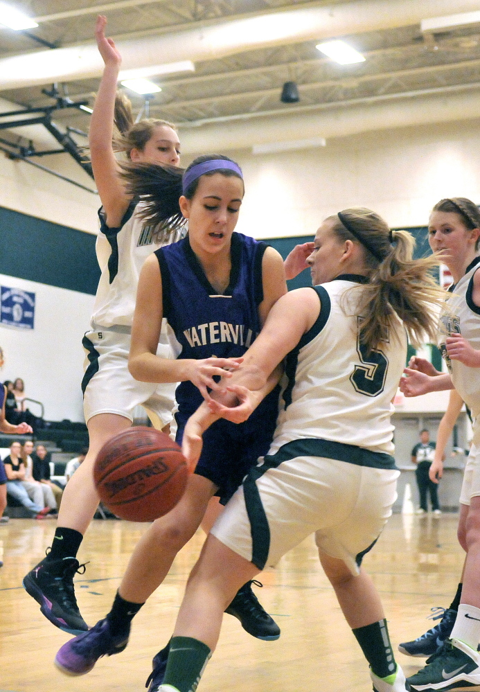 Staff photo by Michael G. Seamans FIGHT FOR IT: : Mt. View High School defenders Courtney Morse, right, and Ashlee Spaulding, 55, left, battle with Waterville’s Fotini Shanos on Tuesday at Mt. View High School in Thorndike on Tuesday.