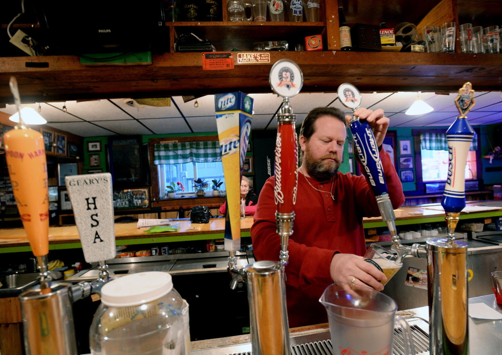 At top, a Portland man uses a food stamp card to buy groceries in 2008. Above, Scott Parker, owner of the Griffin Club in South Portland, pours a beer Tuesday. His club was one of many establishments where misuse of EBT cards may have occurred, according to transaction data released by the LePage administration. Parker said his business accepts cash only, but has an ATM inside where an EBT card can be used. He said people shouldn’t buy alcohol and cigarettes with their welfare cards, but there’s no way for him to track when it’s happening at his club.