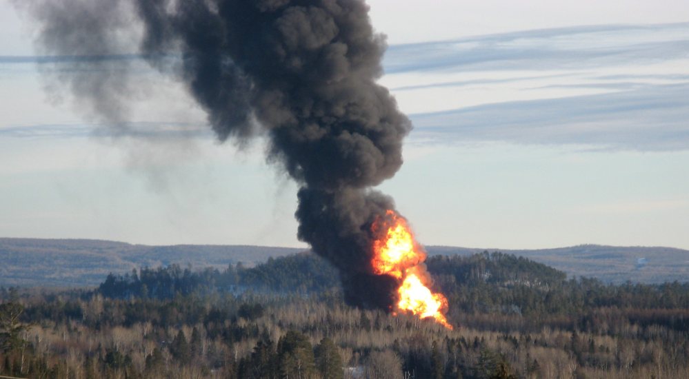 A large fireball rises from the site of a train derailment in New Brunswick, Canada, on Friday as officials used a controlled explosion to blast holes in three tanker cars in the hopes of fighting a large fire that continues to burn two and half days after the incident.