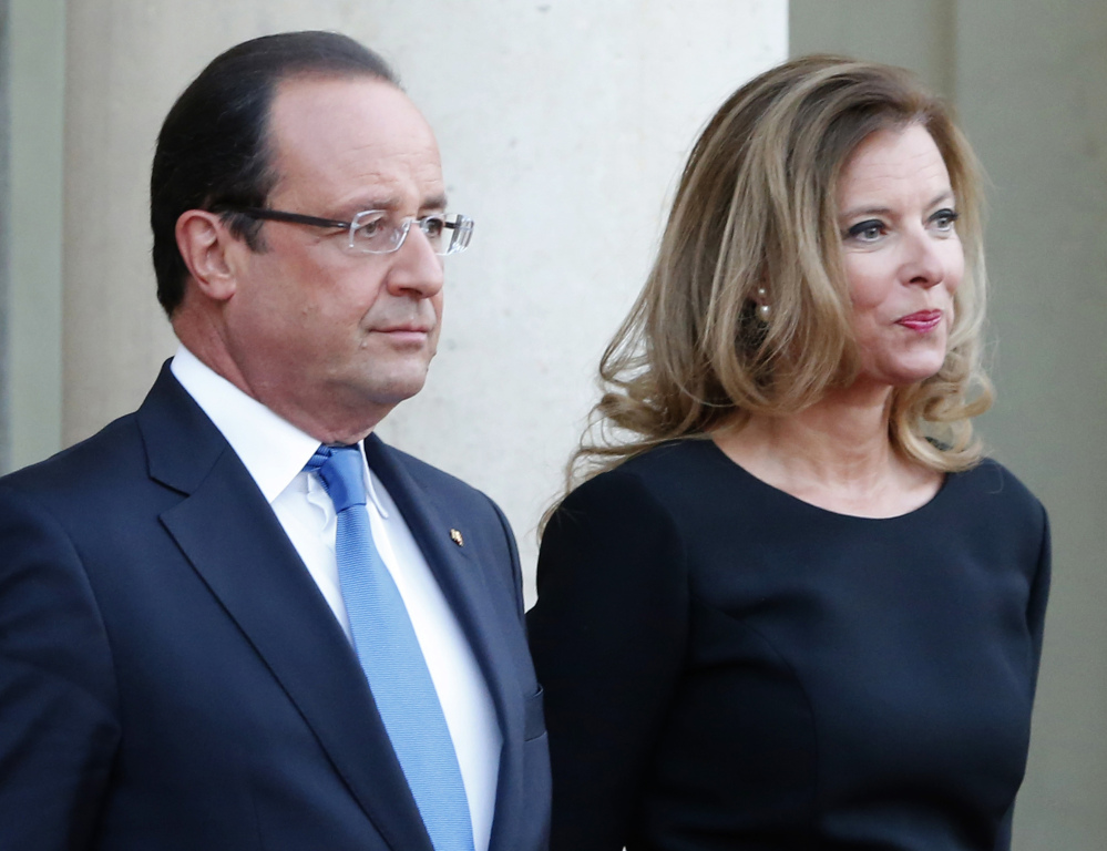 French president Francois Hollande and his companion, Valerie Trierweiler, wait for German President Joachim Gauckand at the Elysee Palace in Paris in this Sept. 3, 2013, photo.