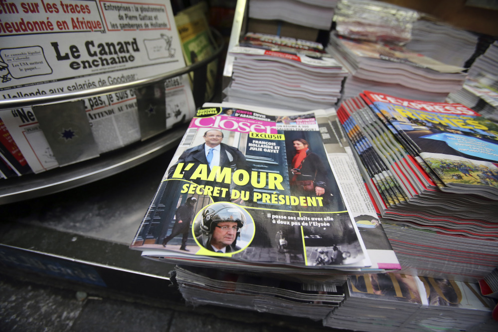 The French magazine Closer, with photos of French President Francois Hollande and French actress Julie Gayet on its front page, is displayed on newspaper rack on the Champs Elysee Avenue in Paris on Friday.