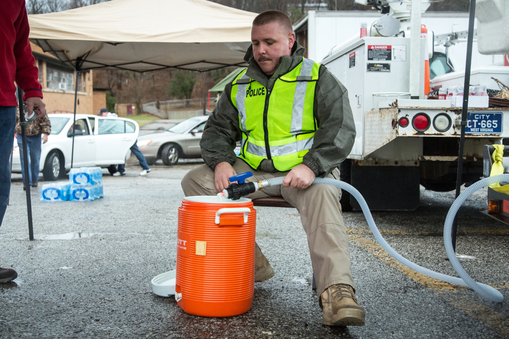 Police Chief Brian Oxley helps distribute water Saturday in Nitro, W.Va., after a chemical spill Thursday in Charleston.