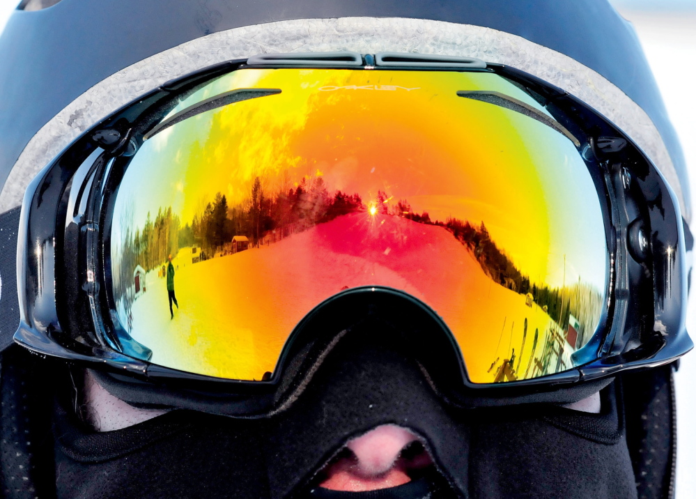 GOOD VIEW: One of the slopes at Titcomb Mountain Ski Area is reflected in the goggles of snowboarder Pete Roberts at the Farmington facility. Roberts has patronized Titcomb since the early ’90s and continues with his daughters. “This is a great local area resource that can’t be beat,” Roberts said.