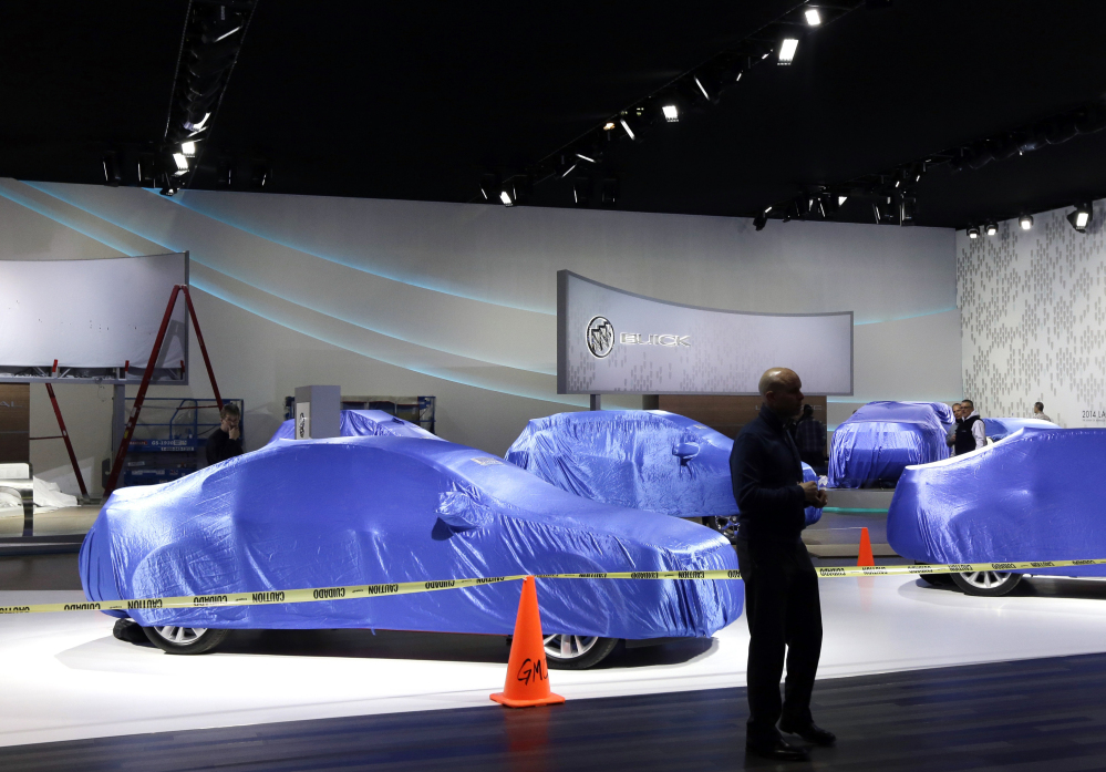 General Motors vehicles are seen under wraps at the Cobo Center, home of the North American International Auto Show in Detroit. What the automakers introduce is crucial because sales growth is starting to slow and new models tend to capture more buyers than older ones.
