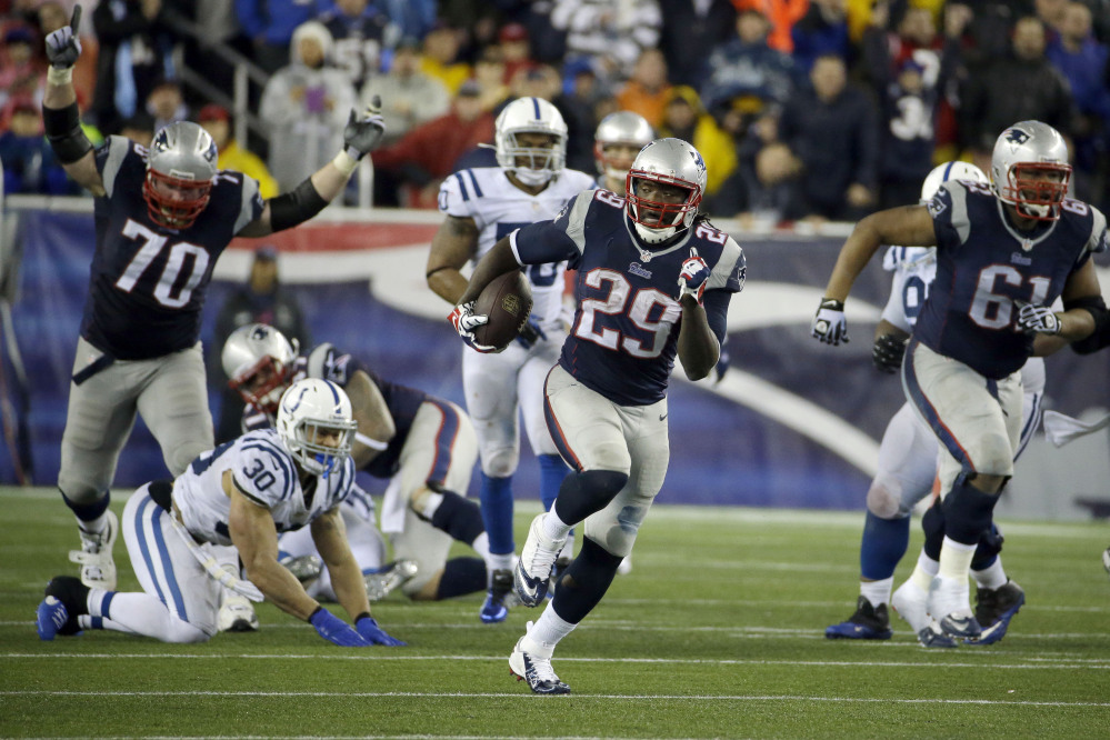 New England Patriots running back LeGarrette Blount (29) heads downfield for a touchdown during the second half of an AFC divisional NFL playoff football game against the Indianapolis Colts in Foxborough, Mass., Saturday, Jan. 11, 2014. (AP Photo/Matt Slocum)