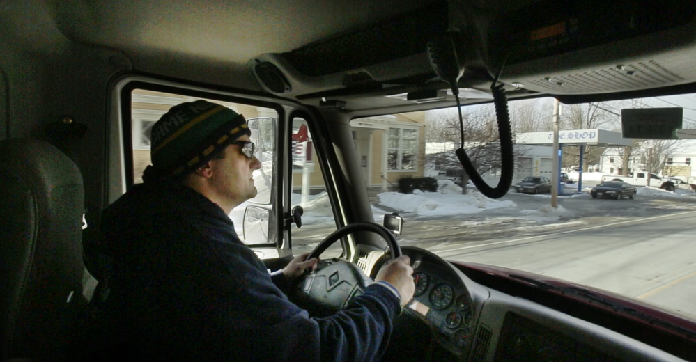 Jim Carroll drives through Limerick village on his way to an oil delivery. Extreme cold and snow and ice storms have made this winter tougher for Maine fuel dealers and their customers, especially those in old homes.