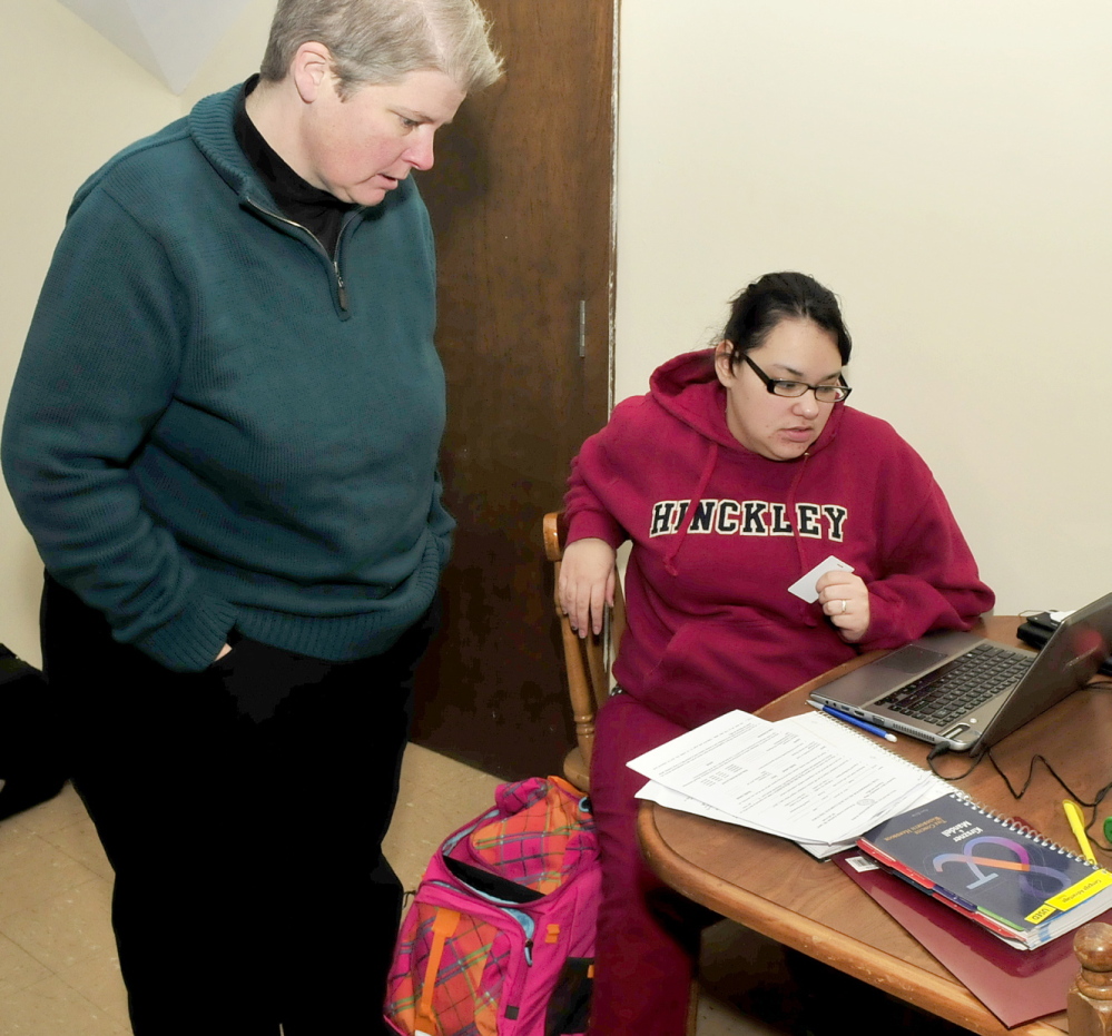 STUDY: Teresa Smith, left, director of admissions, career and transfer services at Kennebec Valley Community College, helps Good Will-Hinckley student Tyneshia Wright with a school project recently. Wright is taking part in the College Step Up program.