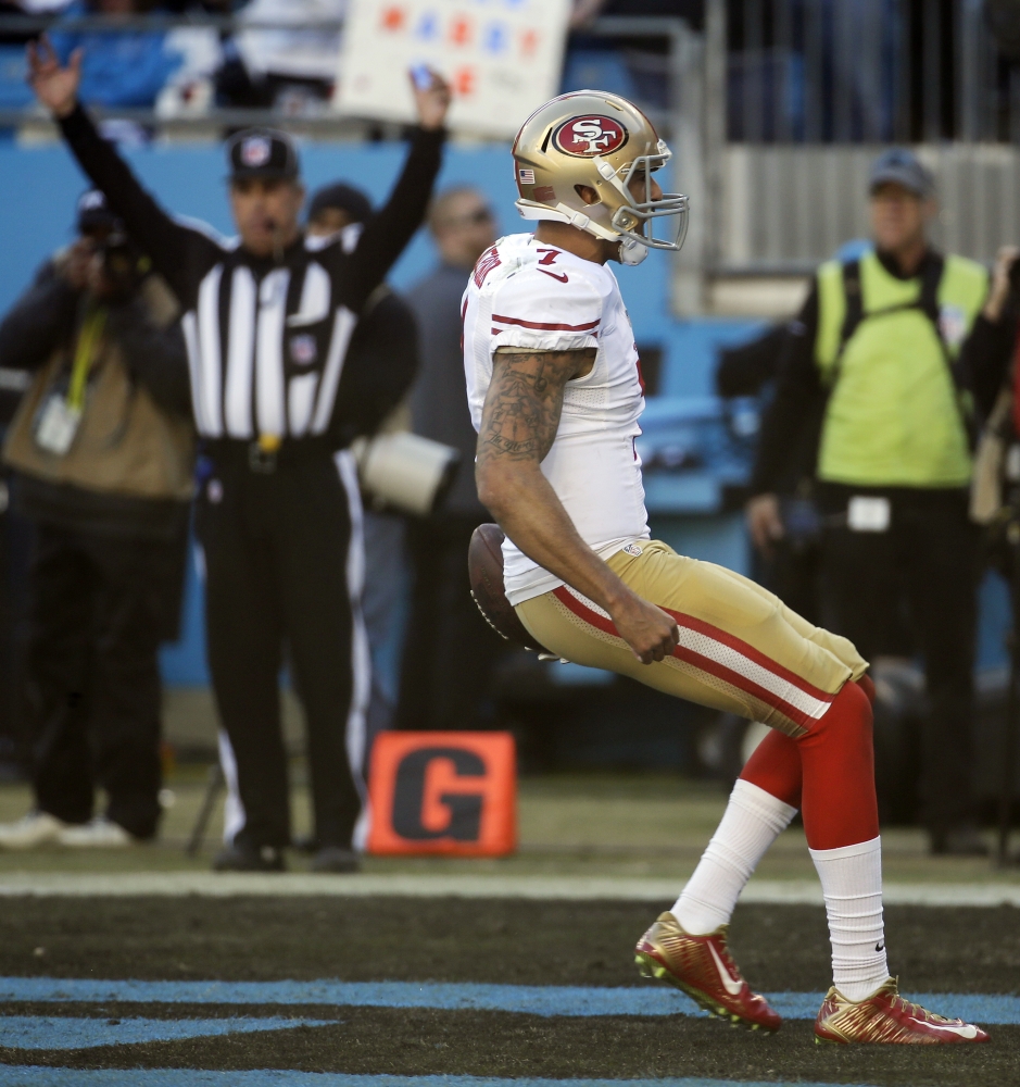 San Francisco 49ers quarterback Colin Kaepernick (7) celebrates his touch-down run against the Carolina Panthers during the second half of a divisional playoff NFL football game, Sunday, Jan. 12, 2014, in Charlotte, N.C. (AP Photo/John Bazemore)