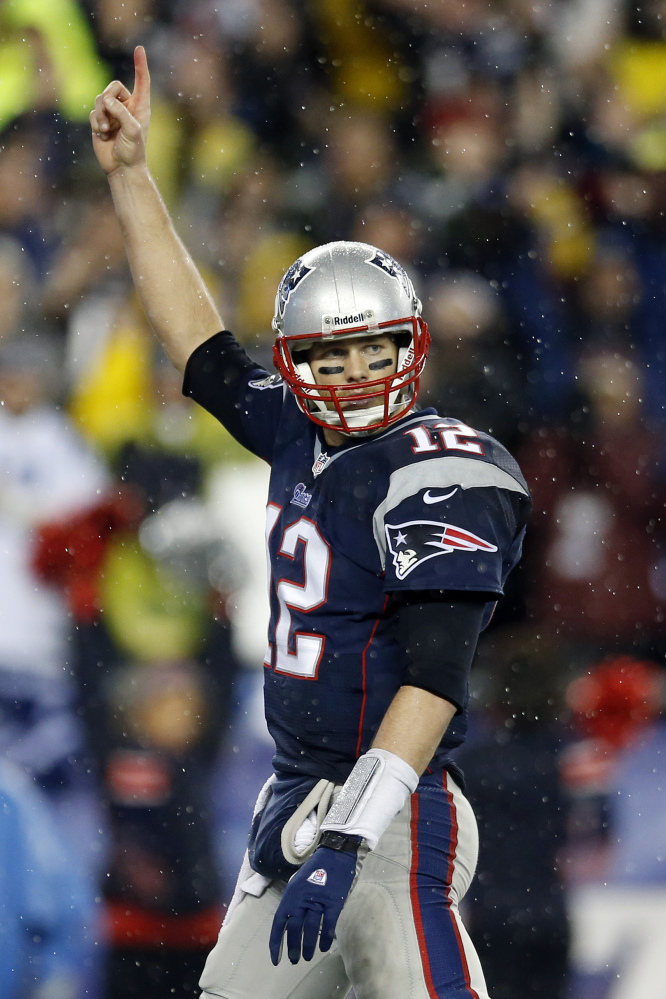 New England Patriots quarterback Tom Brady celebrates running back Stevan Ridley's touchdown during the second half of an AFC divisional NFL playoff football game against the Indianapolis Colts in Foxborough, Mass., Saturday, Jan. 11, 2014. (AP Photo/Michael Dwyer)