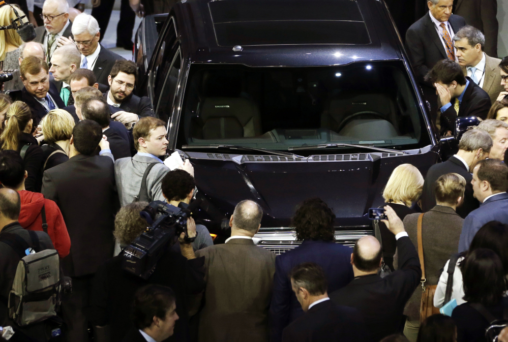Journalists surround the new Ford F-150 at the North American International Auto Show in Detroit on Monday. The new pickup has a body built almost entirely out of aluminum.