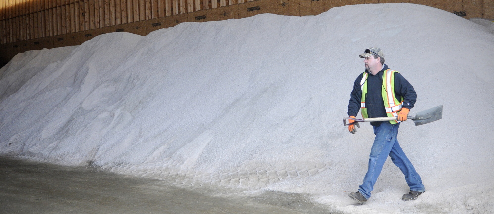 SALT: Augusta Public Works employee Ross Boucher collects a shovel Monday from the city’s salt pile while unloading a plow truck. Icy weather this winter has eaten into municipal sand and salt supplies, but most municipalities expect to make it through the winter if the state doesn’t see a repeat of December weather.