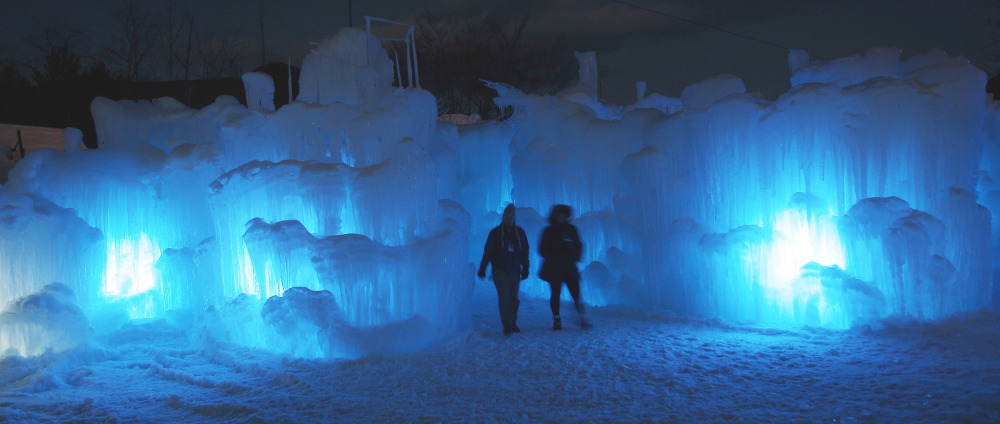 Visitors tour an ice castle at the base of the Loon Mountain ski resort in Lincoln, N.H. The castle has an enclosed slide and a waterfall, and at night is lit by LEDs embedded in the ice. About 8,000 people have visited the castle since it opened Dec. 27. Others are being built in Colorado and Utah.