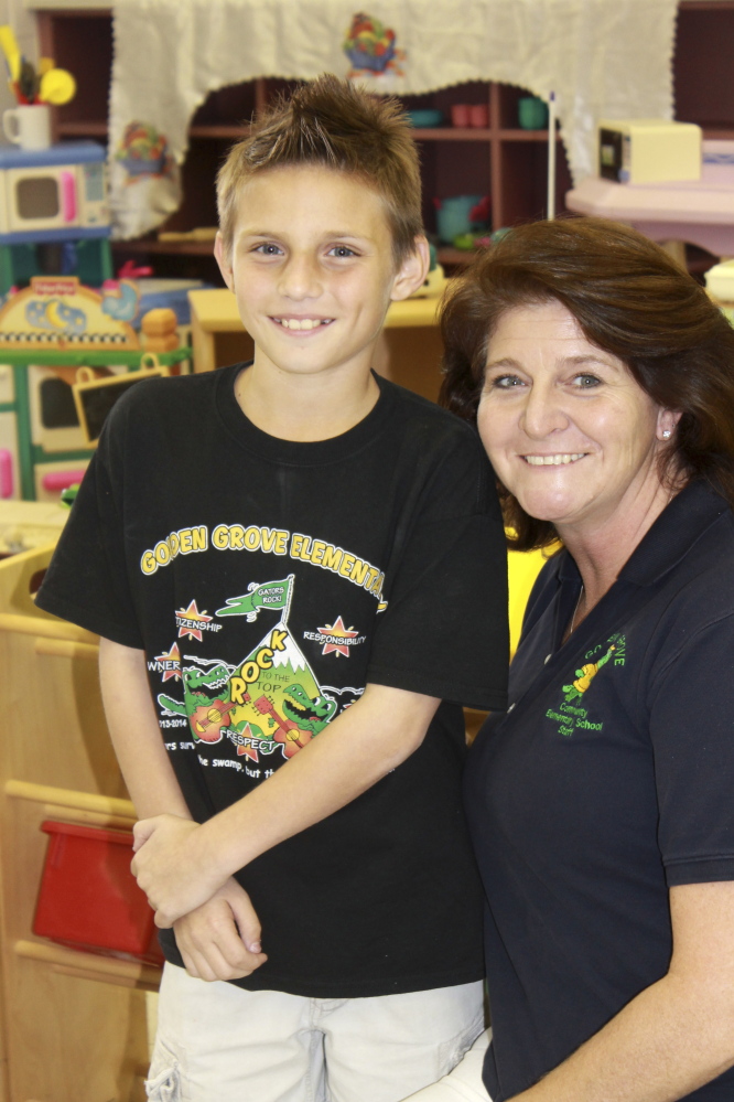 Matthew Palma poses for a photo with Stephanie Dana-Schmidt during a play therapy session at school in West Palm Beach, Fla. Thanks to the Primary Project, Matthew’s mom says his confidence improved dramatically and the now fifth grader isn’t afraid to talk to adults or raise his hand in class.