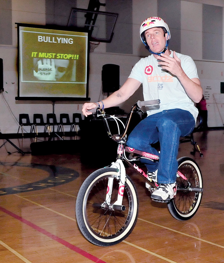 BULLY MESSAGE: Presenter Kevin Robinson rode a bike while delivering his antibullying message to Messalonskee Middle School students in Oakland on Monday. Robinson is an X Games athlete.