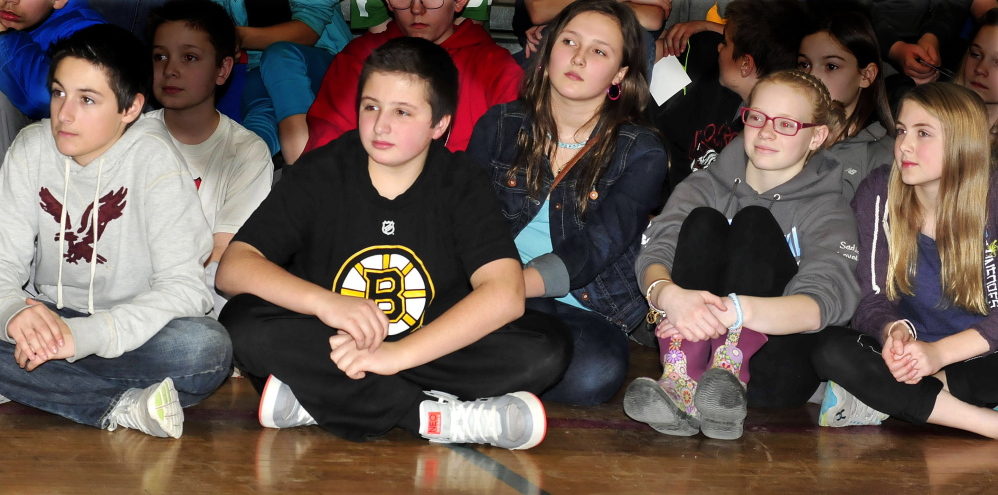 ANTI-BULLYING: Messalonskee Middle School students pay attention to an antibullying presentation by X Games medalist Kevin Robinson in Oakland on Monday. From left are Percy Carey, Blake Marden, Megan McQuillan, Sadie Colby and Addison Littlefield.