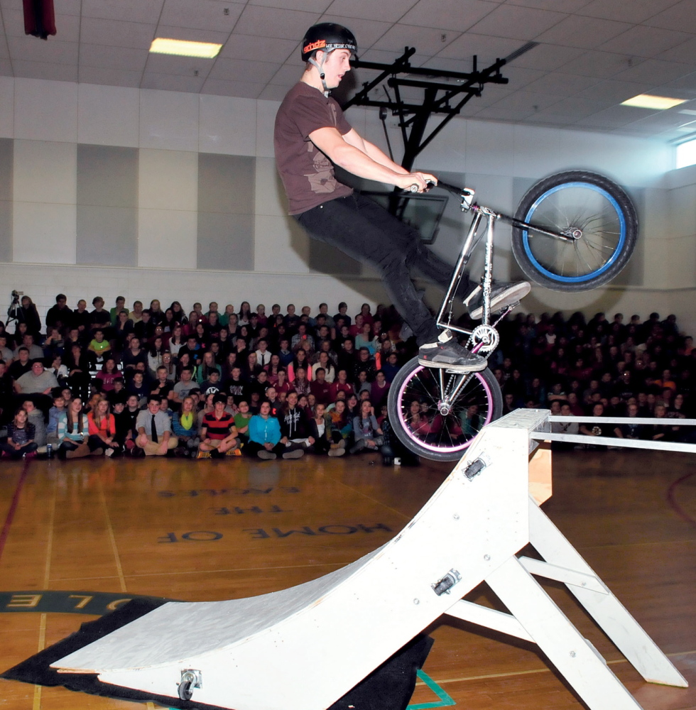 UP BEAT MESSAGE: Ian Bradley rides his bike up a ramp in one of the eye-catching demonstrations that was part of the Bullying Prevention and Living a Positive Lifestyle presentation at Messalonskee Middle School in Oakland on Monday.
