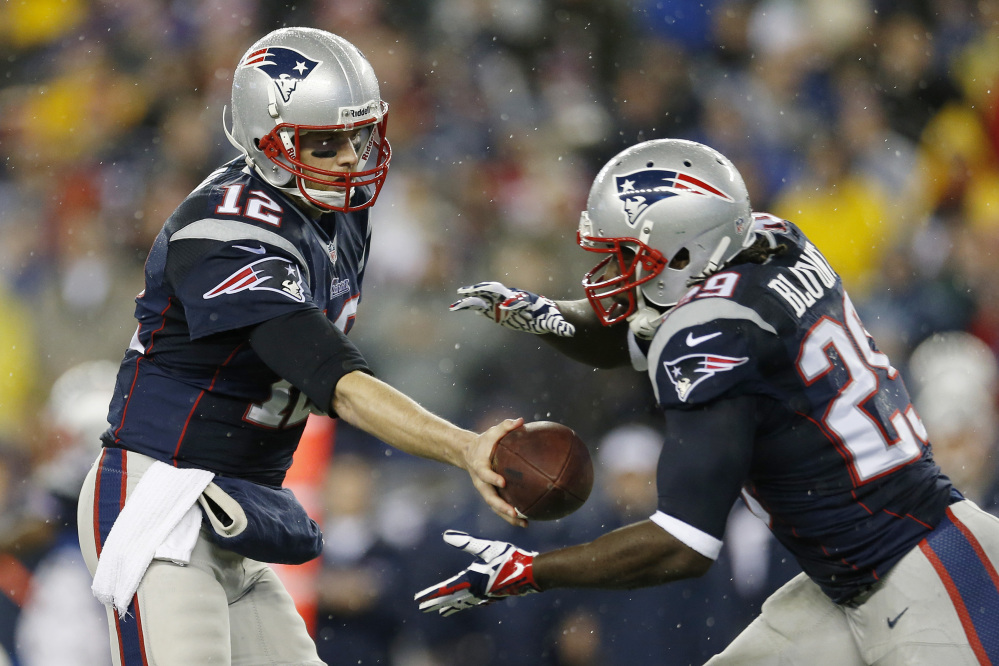 EMBRACING THEIR ROLE: quarterback Tom Brady, left, and running back LeGarrette Blount both expect the Patriots to be underdogs when they face the Denver Broncos in the AFC Championship game on Sunday.