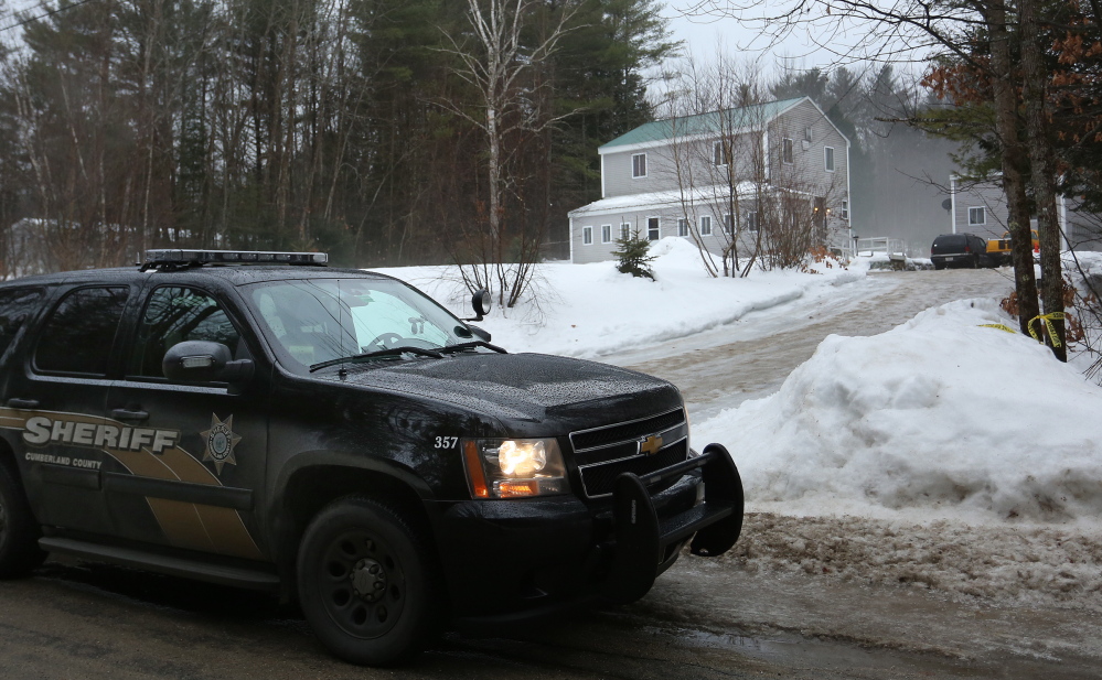 A Cumberland County sheriff’s vehicle sits Tuesday morning outside 20 New Road in Casco, one of two homes invaded by armed intruders earlier in the day. Two of the three suspects, upper left, were arrested in Massachusetts and the third in Fryeburg.