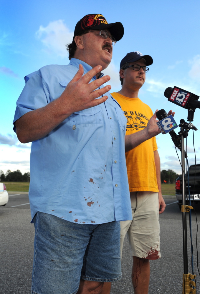 Charles Cummings, left, and Alex Cummings talk to media after witnessing a shooting inside Cobb theater Monday, in Wesley Chapel, Fla.
