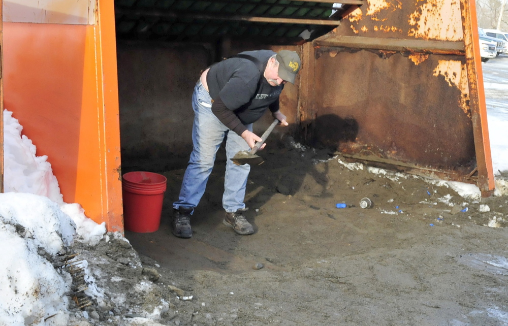 JUST SCRAPING BY: Norridgewock resident Sid Smith scrapes the last of the sand that was available to the public at the town Public Works department. The town is no longer allowing residents to pick up sand because of a shortage from heavy use this winter.
