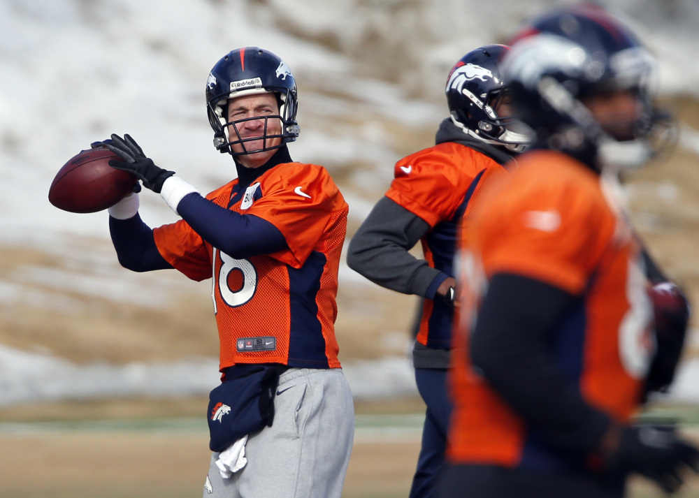 Denver Broncos quarterback Peyton Manning (18) throws during practice for the football team's NFL playoff game against the San Diego Chargers at the Broncos training facility in Englewood, Colo., on Friday, Jan. 10, 2014. (AP Photo/Ed Andrieski)