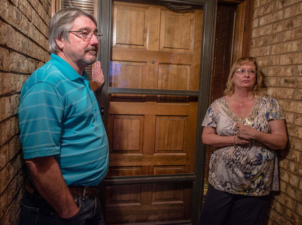 John Masterson and his wife Lea stand outside their door as they talk to the media. Masterson, an eighth-grade teacher, confronted a 12-year-old boy who shot two classmates at the school in New Mexico on Tuesday.