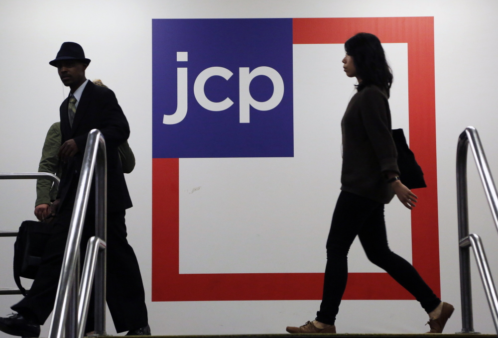 Customers shop at a J.C. Penney store in New York. The company announced cuts Wednesday that should save $65 million annually.