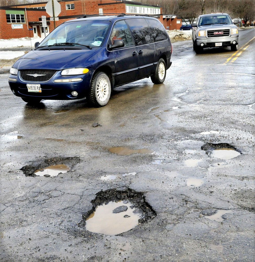 ROUGH RIDE: Motorists have to dodge numerous potholes at the busy intersection of Drummond Avenue and the Armory Road in Waterville on Wednesday.