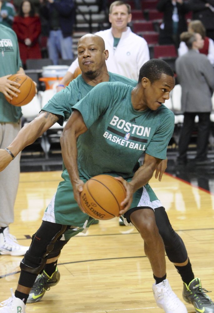 Boston Celtics' Rajon Rondo who is on the injured list works on drills with a team mate prior to an NBA basketball game in Portland, Ore., Saturday Jan.11, 2014. (AP Photo/Greg Wahl-Stephens)