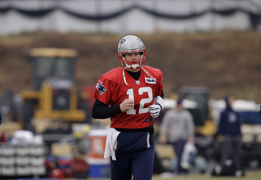 New England Patriots quarterback Tom Brady runs during a drills and stretching session before practice begins at the team’s facility in Foxborough, Mass., on Thursday.