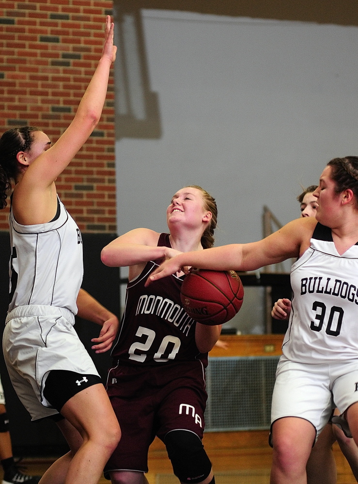 Staff photo by Joe Phelan Monmouth Acadmey junior forward Jenna Davis, middle, is double-teamed by Hall-Dale's Allison Crockett, left, and Molly French during a game on Thursday January 16, 2014 in Hale-Dale High's Penny Memorial Gym in Farmingdale.