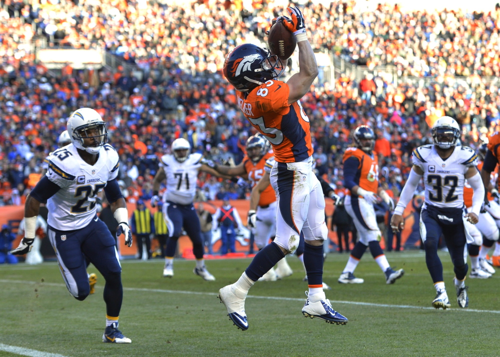 Wes Welker catches a pass for a touchdown against the San Diego Chargers in the AFC division playoff football game on Jan. 12, 2014.
