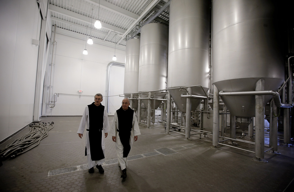 Father Damion, abbot at St. Joseph’s Trappist Abbey, left, and Spencer Brewery Director Father Isaac walk through their new, state-of-the-art facility in Spencer, Mass., this month. The Spencer Brewery began brewing Spencer Trappist Ale recently, becoming only the ninth certified brewery of Trappist beers in the world and the only one outside of Europe.