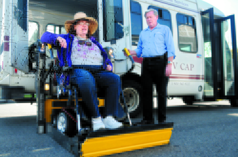 Cindy Dow is lifted into a KV CAP bus in October at her Augusta home for a ride to a medical appointment. The troubled MaineCare rides system could be on the brink of a solution, lawmakers said.