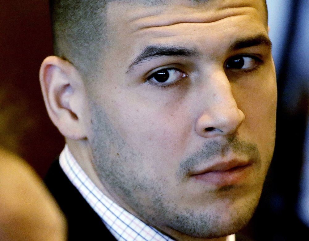 Former New England Patriot football player Aaron Hernandez is awaiting trial on murder charges in a 2013 shooting near his home.