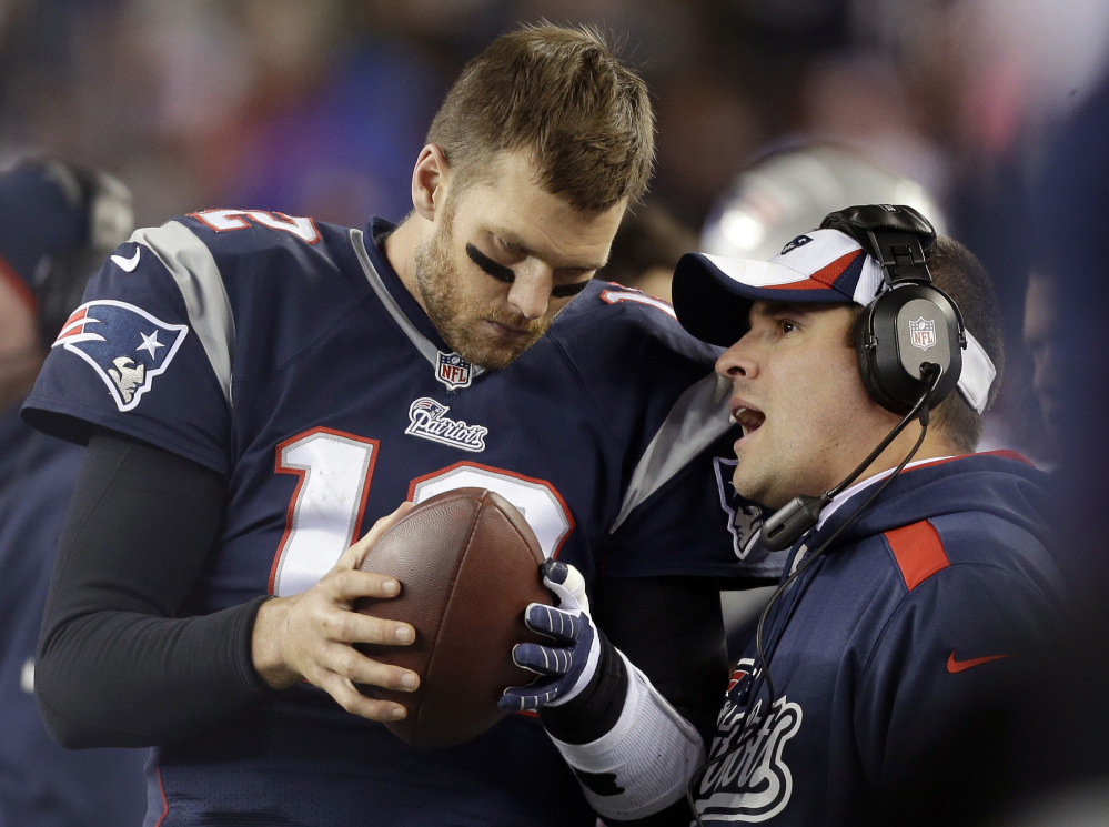 NOT WELL LIKED: New England Patriots offensive coordinator Josh McDaniels, right, talks to quarterback Tom Brady earlier this season. McDaniels was the head coach in Denver for two years and his name stirs plenty of angst among Bronco fans.