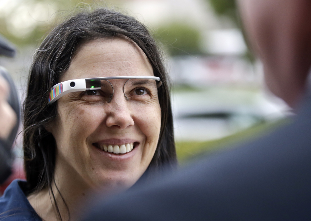 Cecilia Abadie wears her Google Glass as she talks with her attorney outside San Diego traffic court in this Dec. 3, 2013, photo.