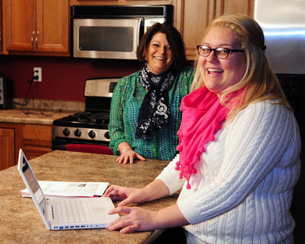 APPLYING: Erica Bean, left, and her daughter Hanna Turgeon talk about applying for college financial aid Wednesday at their Sidney home. Turgeon plans to study nursing at University of Maine at Fort Kent.