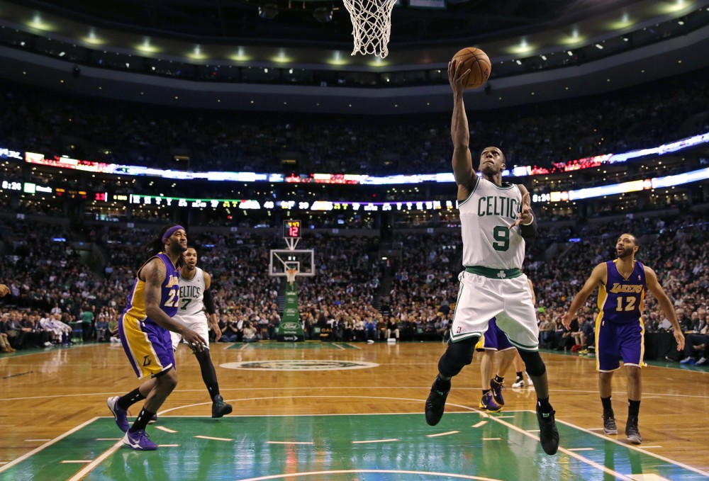 Boston Celtics guard Rajon Rondo (9) drives to the basket against the Los Angeles Lakers9during the second quarter of an NBA basketball game in Boston, Friday, Jan. 17, 2014. Rondo returned to the court for the first time this season, after undergoing surgery on his right knee. (AP Photo/Charles Krupa)