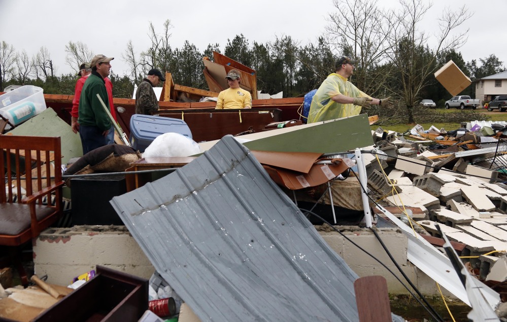 In this April 11, 2013 photo, Shuqualak, Miss. residents begin cleanup after a tornado plowed through rural sections of eastern Mississippi, killing at least one person and causing widespread damage and power outages, officials said. The Storm Prediction Center plans to broaden its days-in-advance warning system after finding that the days labeled with a “slight risk” turned out to have storms that were fairly stout – and even deadly.