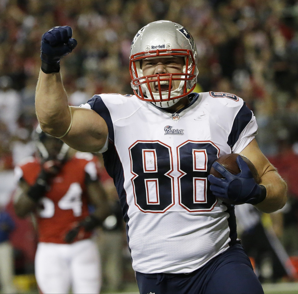 FILE - New England Patriots tight end Matthew Mulligan celebrates his touchdown against the Atlanta Falcons during the first half of an NFL football game, in this, Sept. 29, 2013 file photo taken in Atlanta. (AP Photo/David Goldman, File)