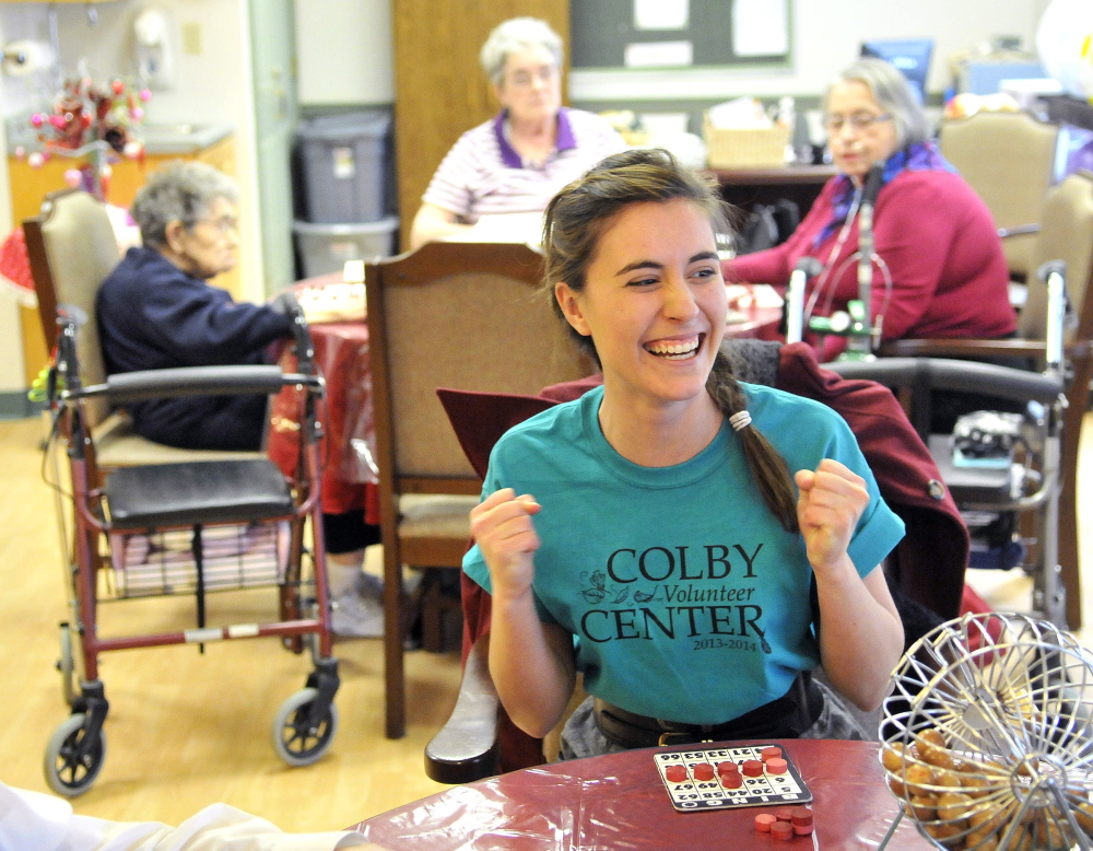 Staff photo by Michael G. SeamansNUMBER CRUNCHER: Colby College senior Theresa Petzoldt, 21, celebrates her victory in a game of bingo during an afternoon of volunteering Saturday at Sunset Home in Waterville. Colby students volunteered throughout Waterville in honor of Martin Luther King Jr.